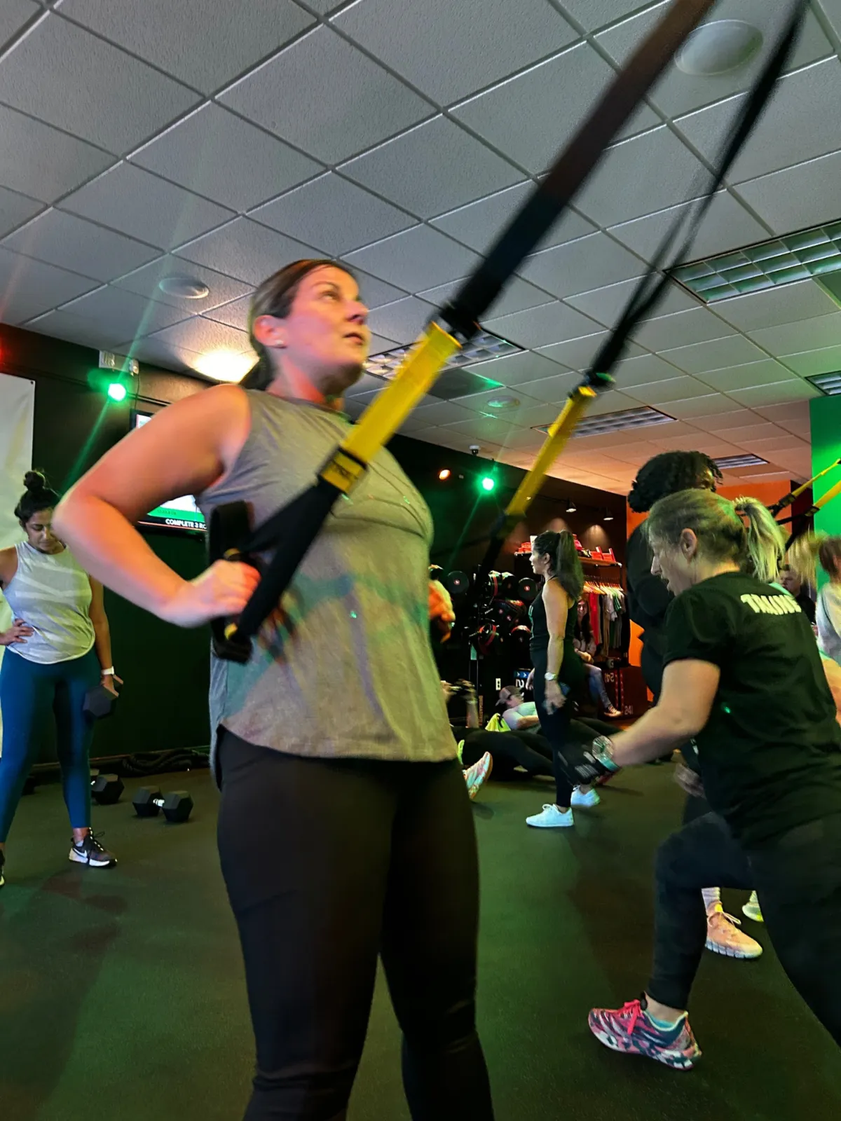 Members training with TRX straps in a ReFuel Bootcamp class